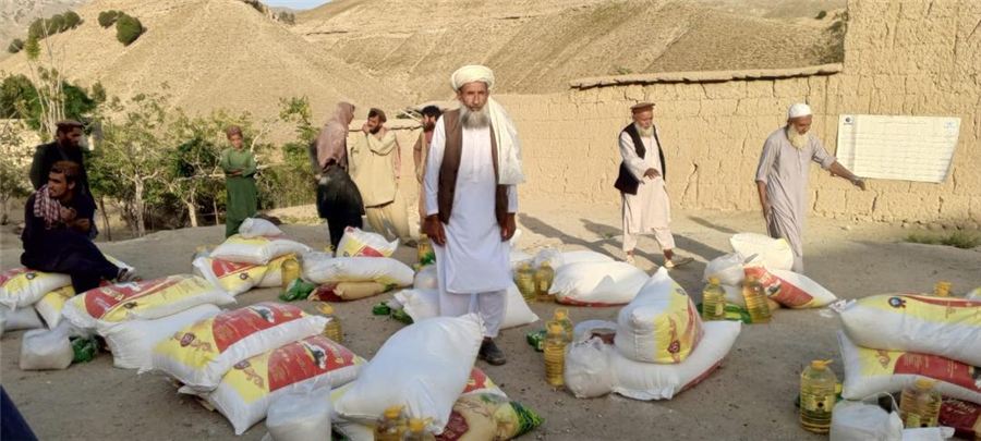 ARP food assistance distribution of flour and cooking oil in a rural Afghan village