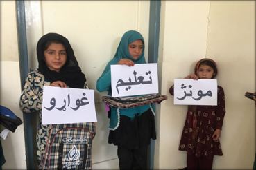 Children holding signs asking for education