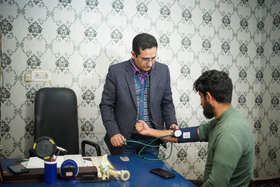 Doctor checking a patient's blood pressure at a clinic